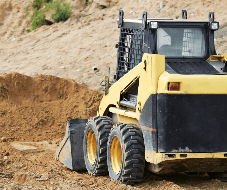 Skid steer leveling a dirt pad